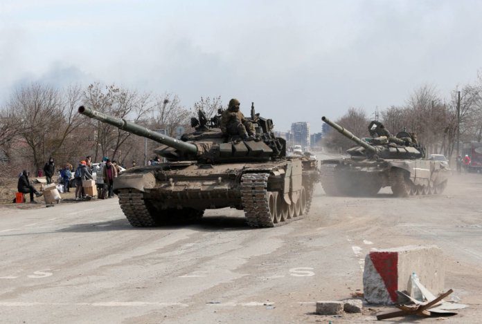 Service members of pro-Russian troops are seen in the besieged city of Mariupol